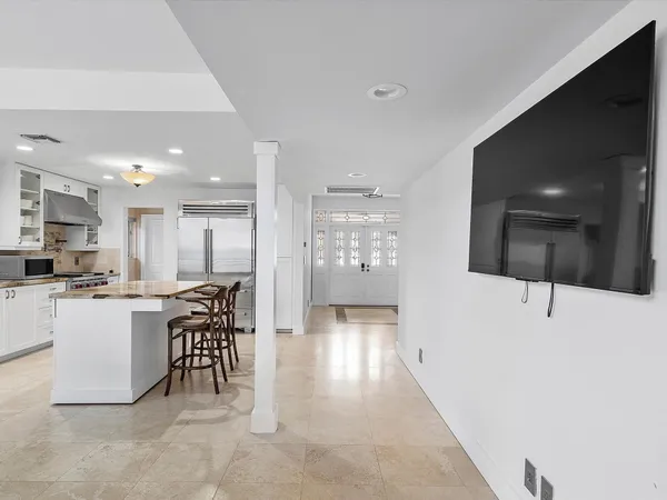 a kitchen with stainless steel appliances granite countertop a stove and a white cabinets