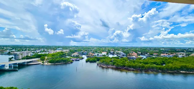 a living room with furniture a flat screen tv and a chandelier