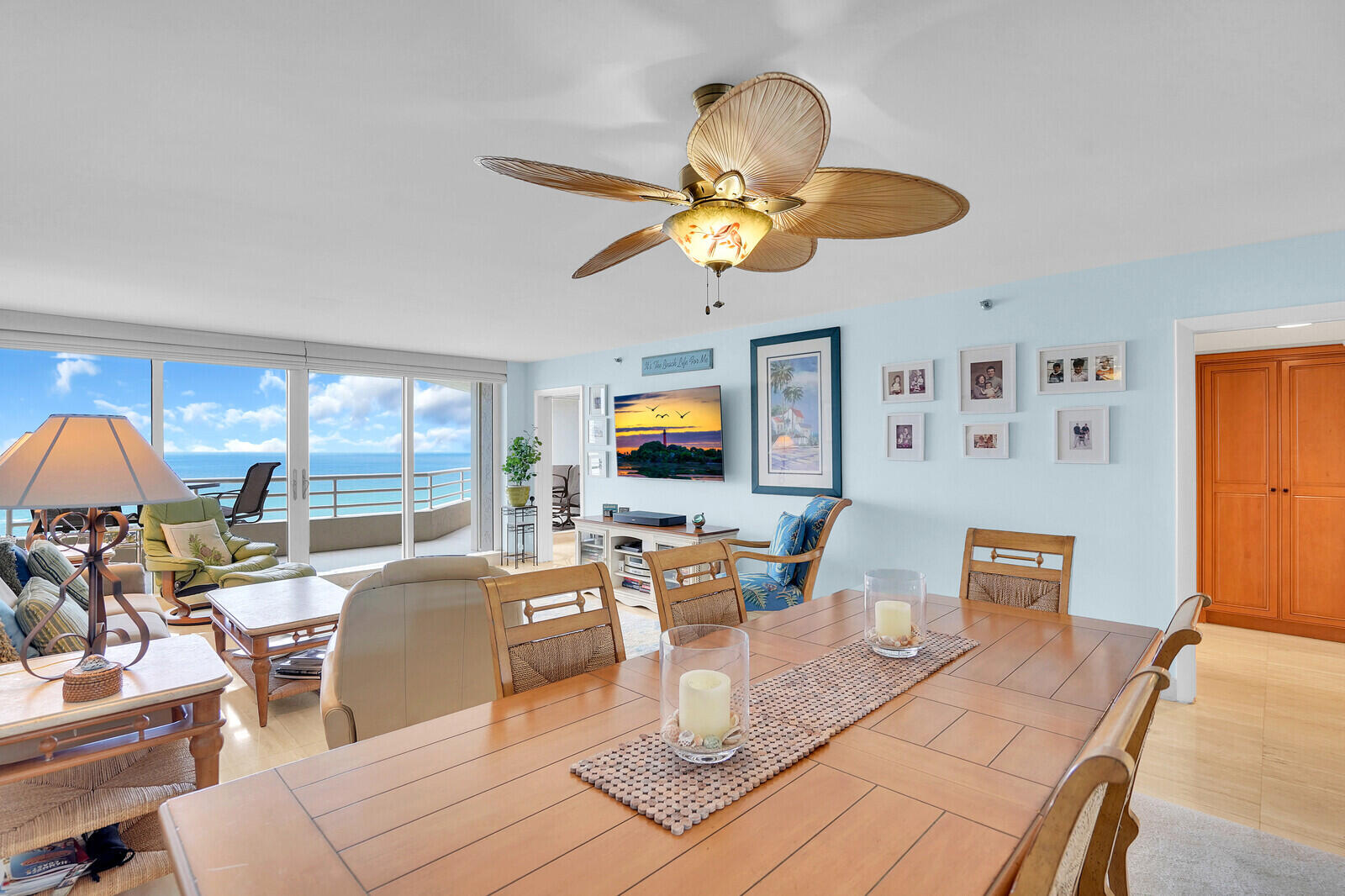 4101 North Ocean Boulevard, Unit 1604 Boca Raton, FL 33431 - Photo 16 of 51 a living room with furniture a flat screen tv and a chandelier