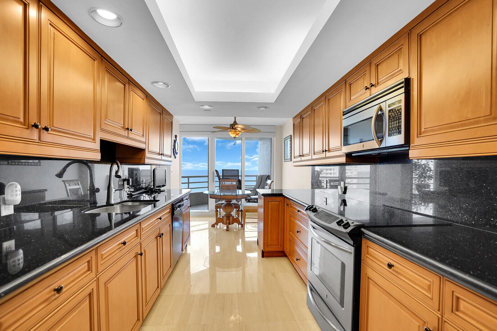 4101 North Ocean Boulevard, Unit 1604 Boca Raton, FL 33431 - Photo 25 of 51 a large kitchen with stainless steel appliances granite countertop a sink a stove and cabinets