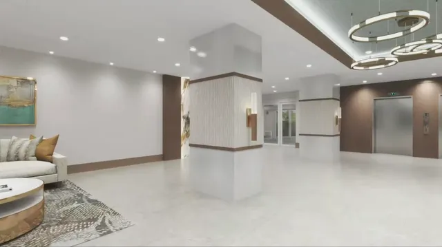 a view of a hallway with bathroom and a sink