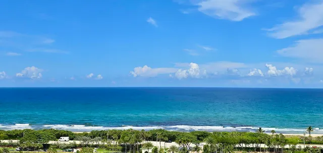 a view of swimming pool with outdoor seating and lake