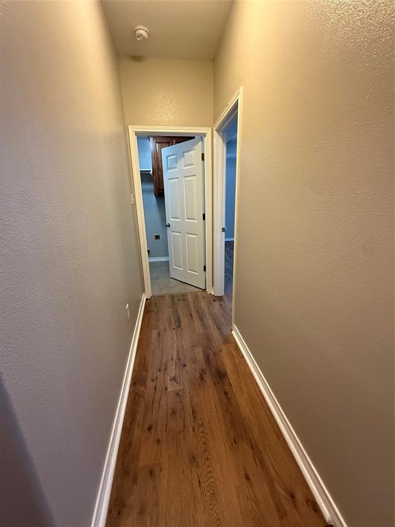 1302 Lewis And Clark Trail Abilene, TX 79602 - Photo 20 of 37 a view of a hallway with wooden floor