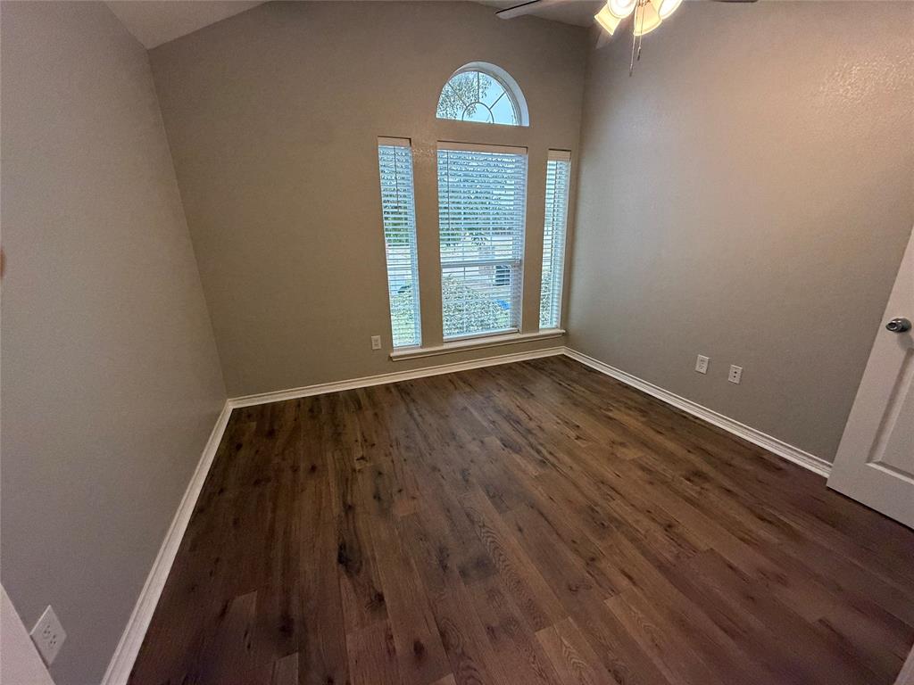 1302 Lewis And Clark Trail Abilene, TX 79602 - Photo 22 of 37 an empty room with wooden floor a exposed radiator and a window