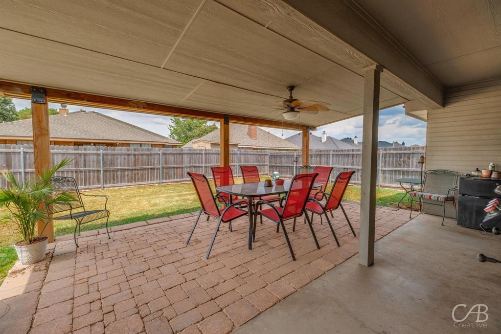 1302 Lewis And Clark Trail Abilene, TX 79602 - Photo 31 of 37 a view of a patio with a table chairs and a backyard