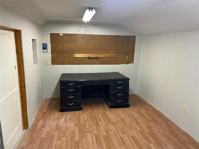 a view of room with wooden floor and closet