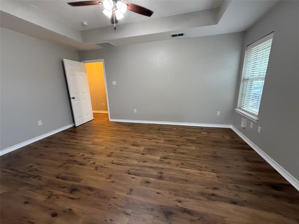 1302 Lewis And Clark Trail Abilene, TX 79602 - Photo 7 of 37 wooden floor in an empty room with a window