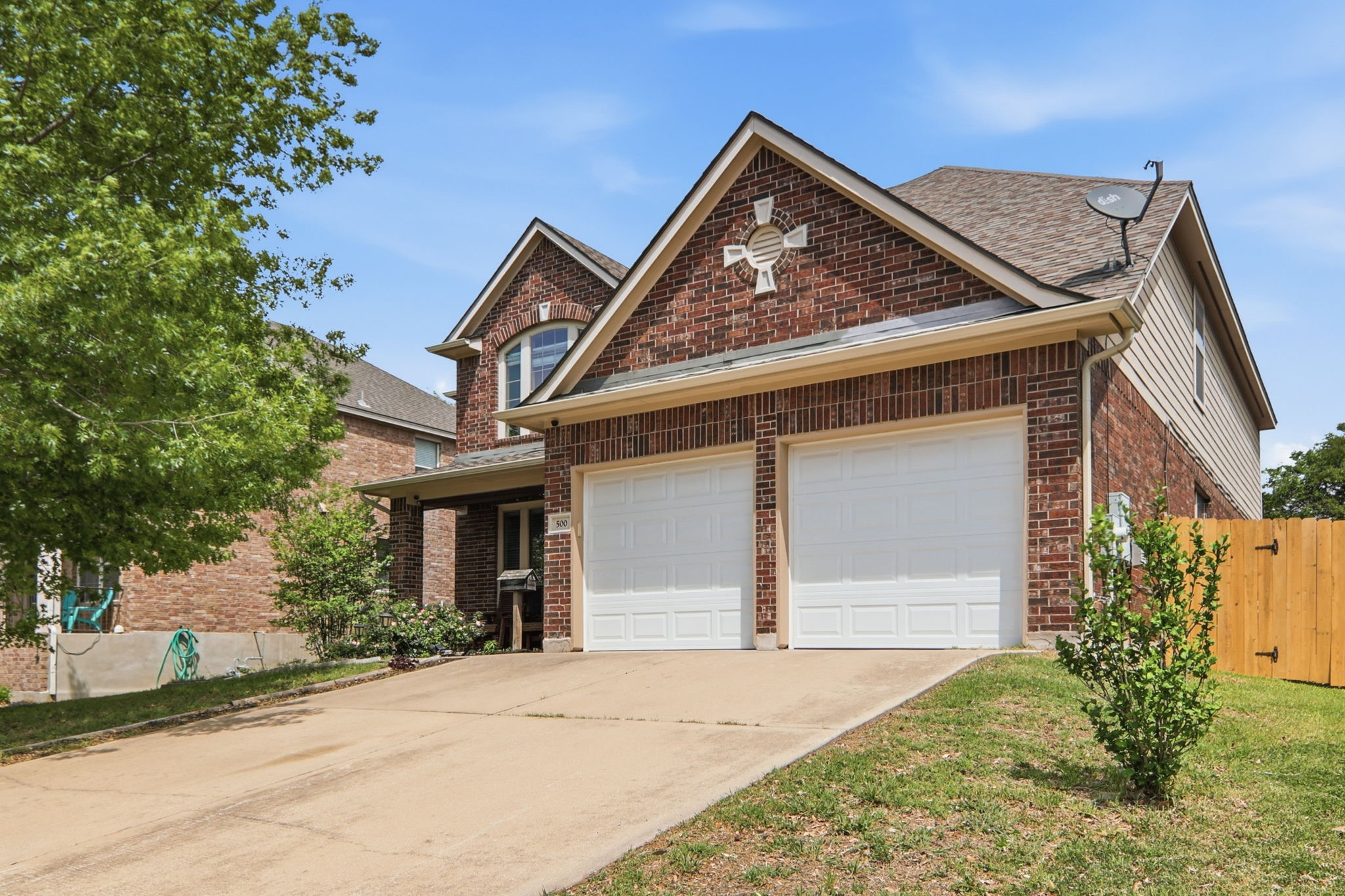 500 Red Hawk Drive Leander, TX 78641 - Photo 1 of 1 Traditional-style home with driveway, brick siding, a gate, and a garage