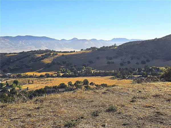 a view of a yard with mountains in the background