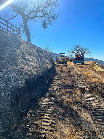 a view of mountain with sunset in background