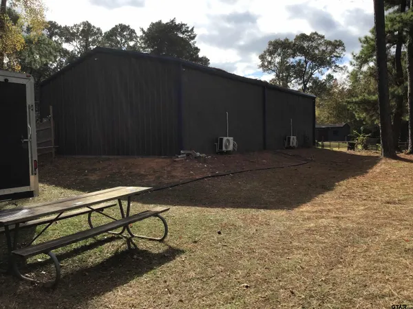 a view of a backyard with wooden fence