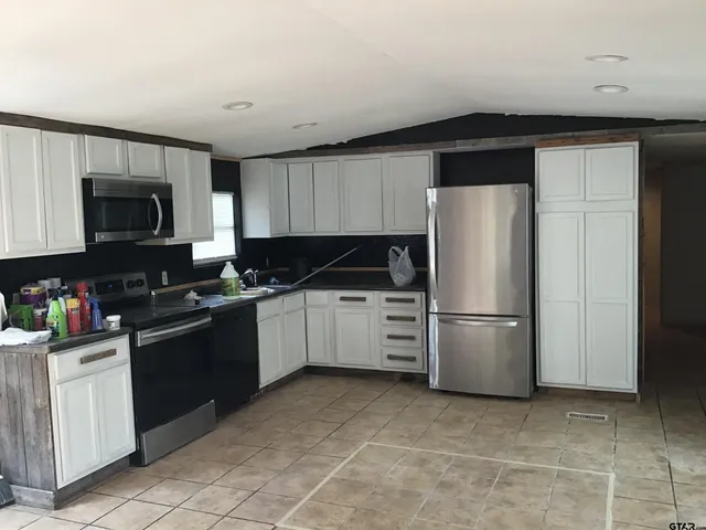 a kitchen with a refrigerator stove and microwave