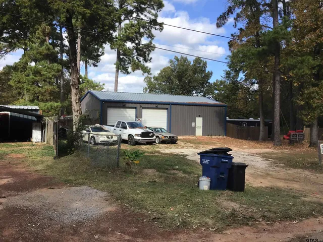 a view of a house with backyard tub and chairs