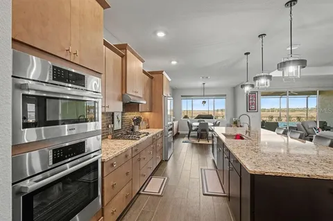 a large kitchen with lots of counter space and stainless steel appliances