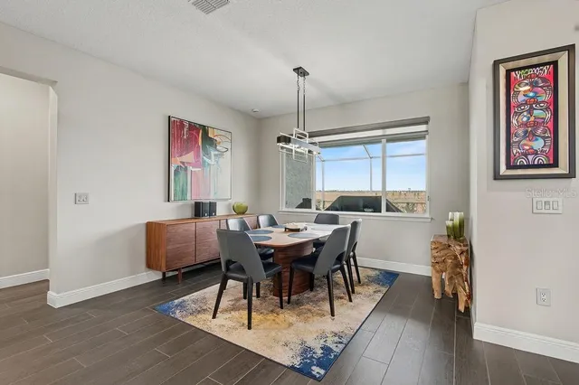 a view of a dining room with furniture window and wooden floor