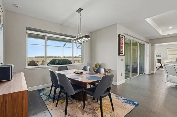 a view of a dining room with furniture window and wooden floor