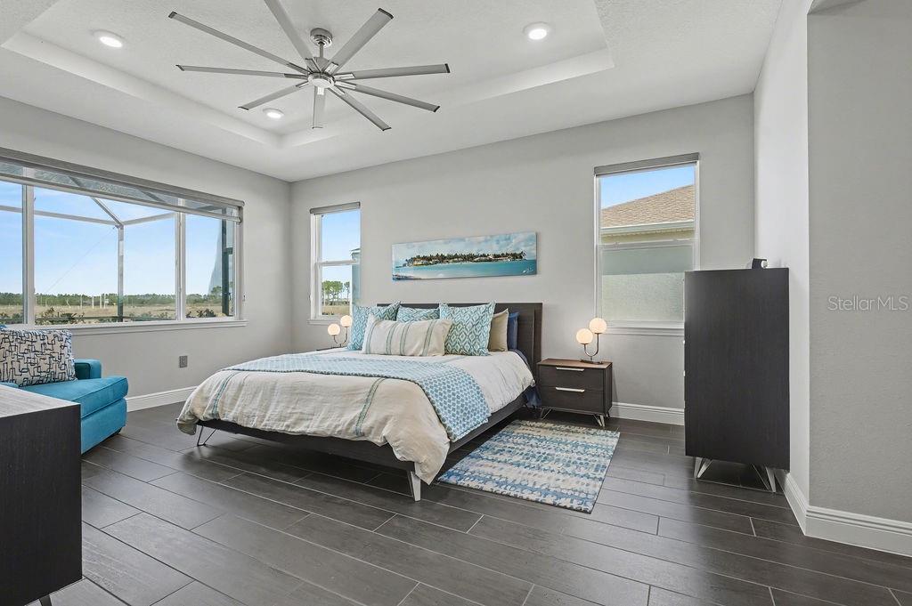 9963 Southwest 82nd Street Road Ocala, FL 34481 - Photo 14 of 43 a bedroom with a bed painting on wall and a large window