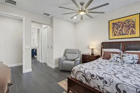 a bedroom with a bed and a painting on the wall