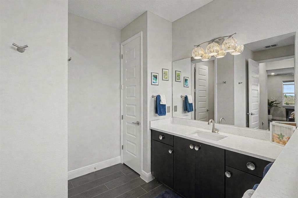 9963 Southwest 82nd Street Road Ocala, FL 34481 - Photo 25 of 43 a bathroom with a double vanity sink and a mirror