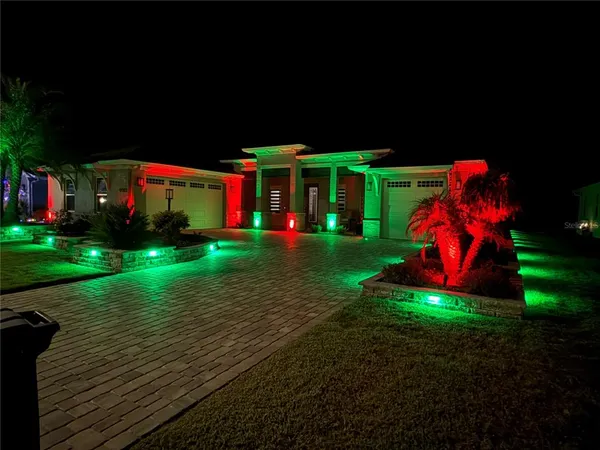 a view of a house with backyard and sitting area