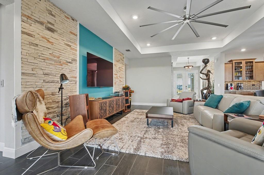 9963 Southwest 82nd Street Road Ocala, FL 34481 - Photo 7 of 43 a living room with furniture and a flat screen tv
