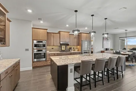 a large kitchen with a table and chairs