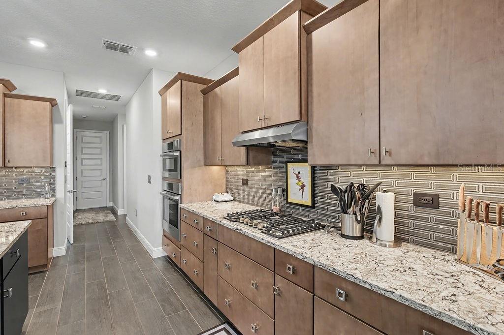 9963 Southwest 82nd Street Road Ocala, FL 34481 - Photo 10 of 43 a kitchen with sink refrigerator and stove