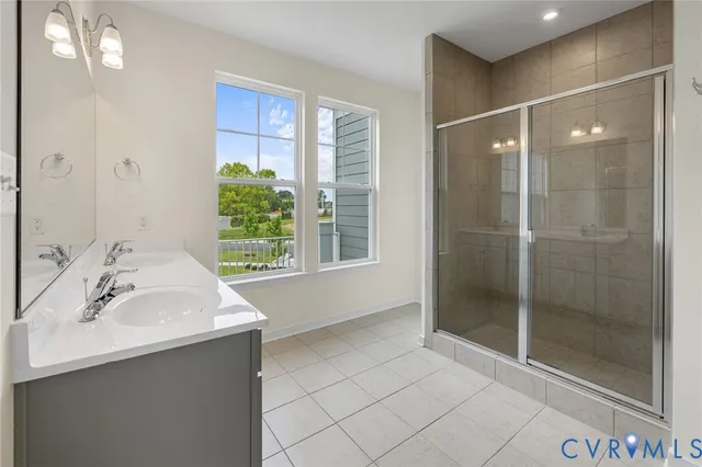 a bathroom with a shower sink and mirror