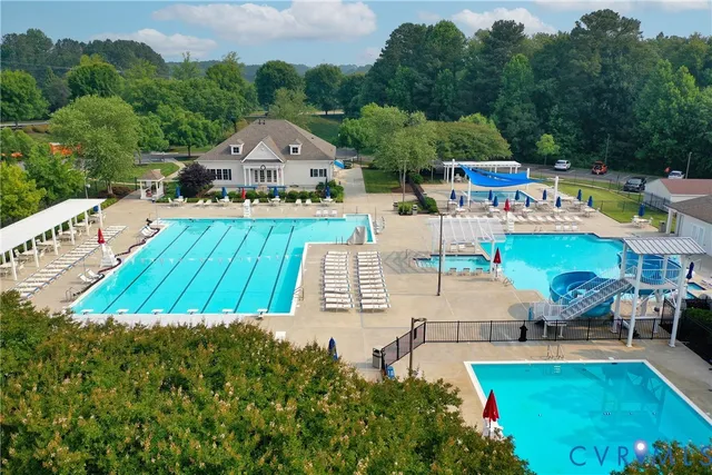 a view of a house with pool and chairs