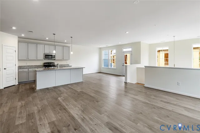 a kitchen with granite countertop a stove top oven and cabinets