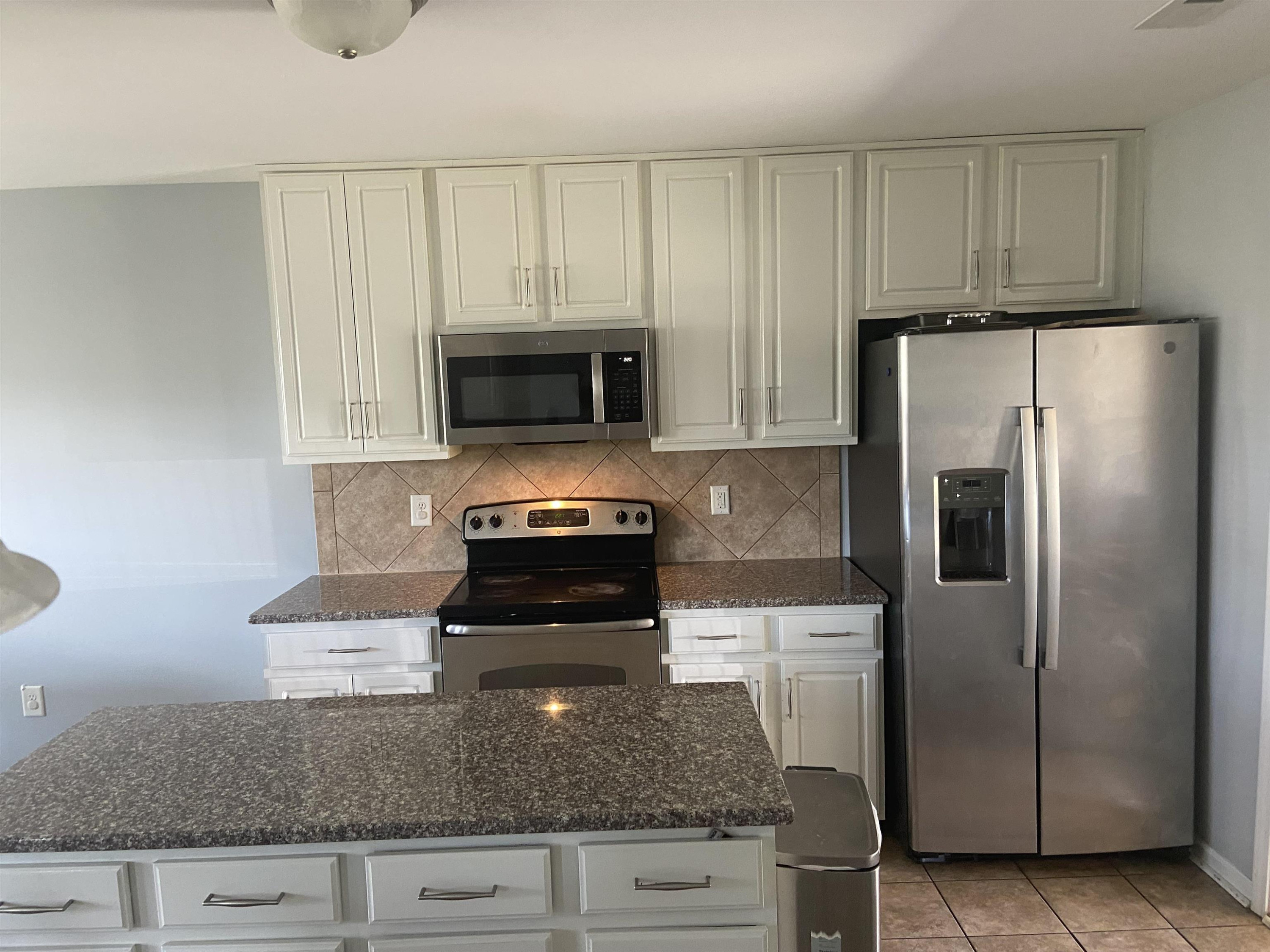 95 Red Coat Drive Cameron, NC 28326 - Photo 13 of 35 a kitchen with granite countertop a refrigerator stove and microwave