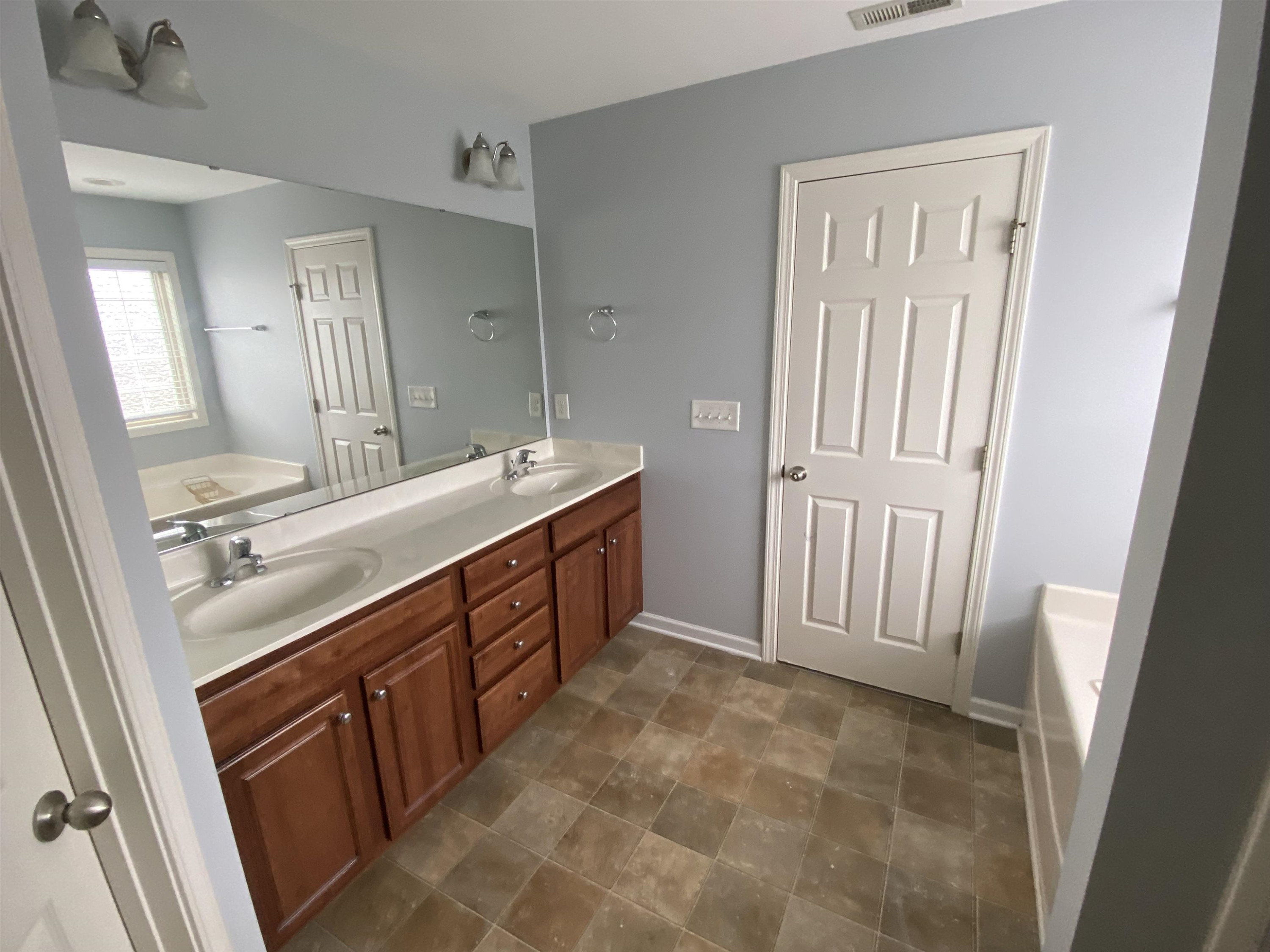 95 Red Coat Drive Cameron, NC 28326 - Photo 20 of 35 a bathroom with a double vanity sink a and a mirror