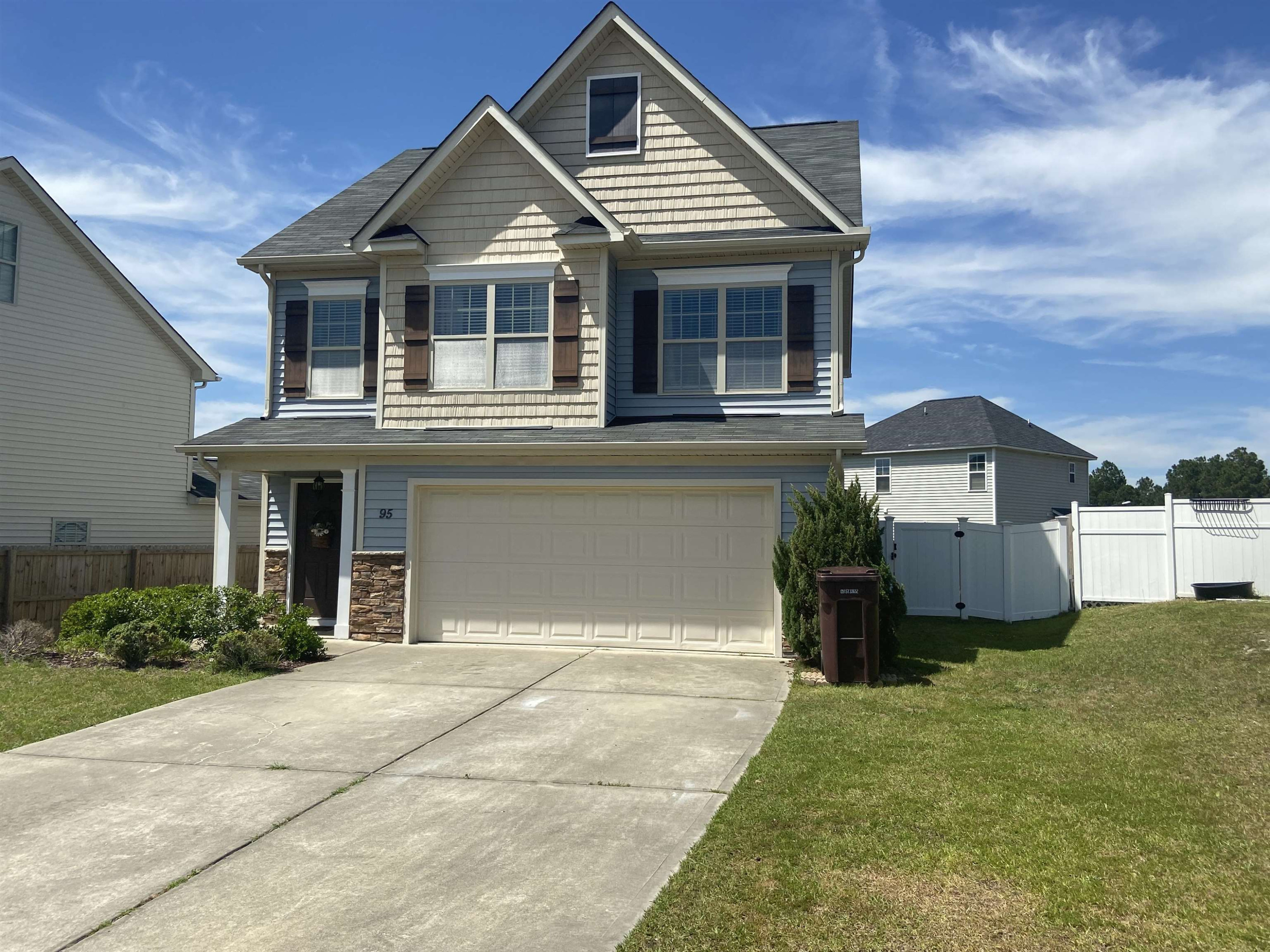 95 Red Coat Drive Cameron, NC 28326 - Photo 2 of 35 a front view of a house with a yard and garage