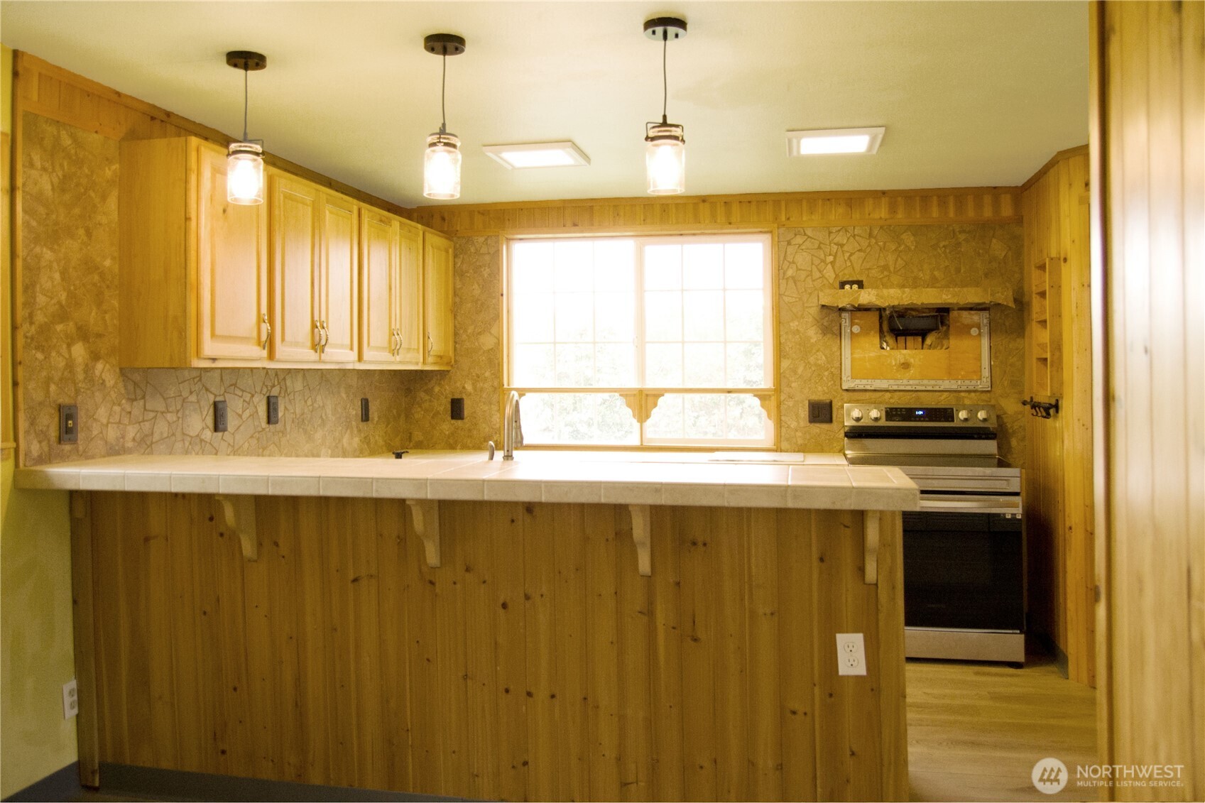393 Flora Place Forks, WA 98331 - Photo 11 of 26 a kitchen with a sink and cabinets