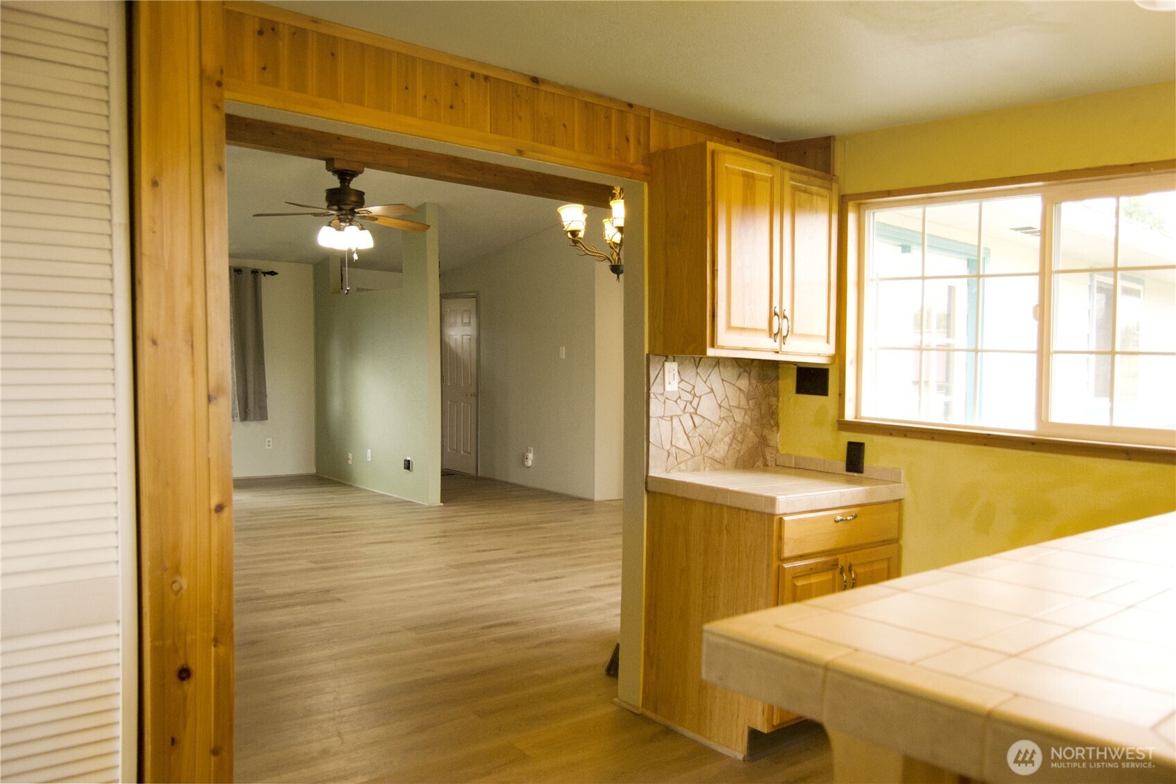 393 Flora Place Forks, WA 98331 - Photo 15 of 26 a spacious bathroom with a granite countertop sink and a mirror