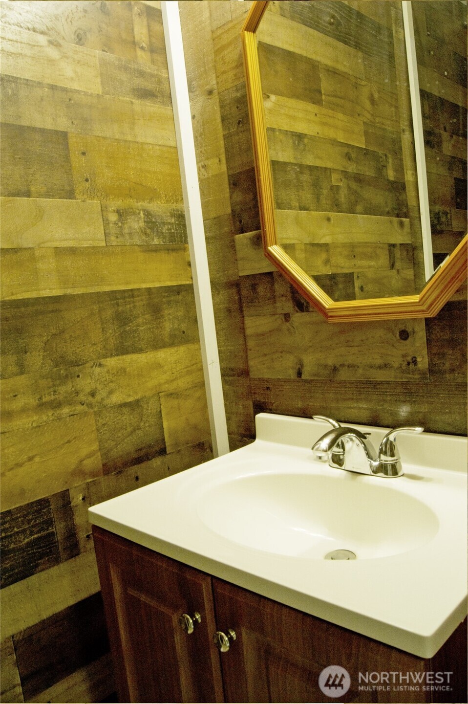 393 Flora Place Forks, WA 98331 - Photo 26 of 26 a bathroom with a sink and a mirror