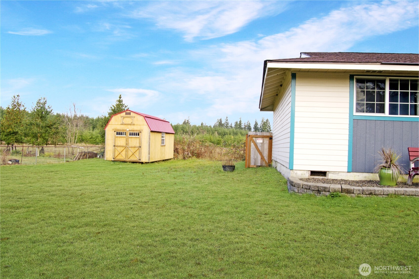 393 Flora Place Forks, WA 98331 - Photo 3 of 26 a front view of a house with garden