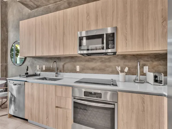 a living room with furniture a flat screen tv and outdoor seating