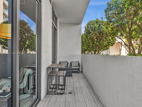 a bedroom with a bed television on desk and a window