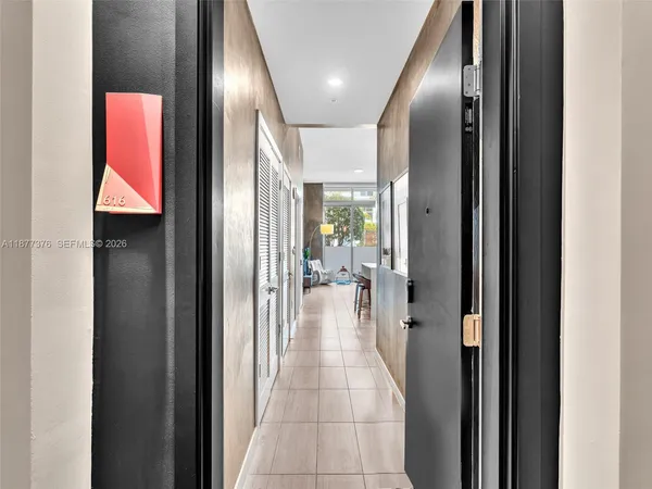 a kitchen with a table chairs refrigerator and cabinets