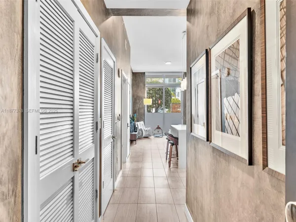 a kitchen with stainless steel appliances granite countertop a refrigerator a sink and white cabinets