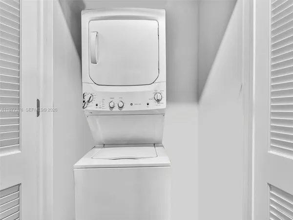 a view of living room kitchen with granite countertop wooden floor and a living room
