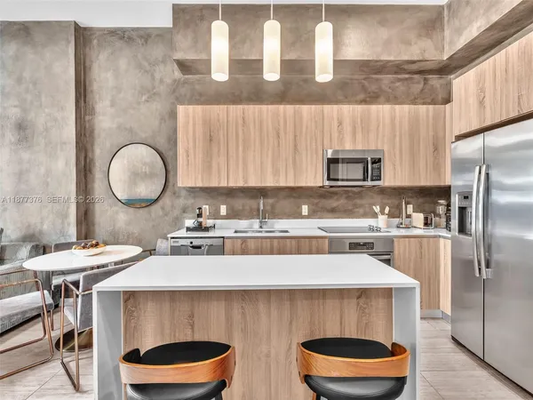 a room with furniture a large window and a chandelier