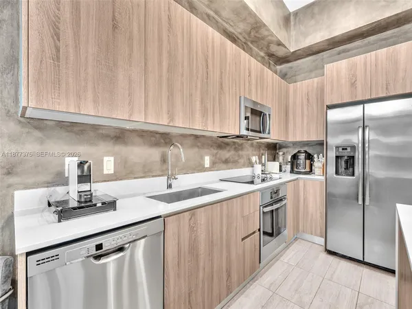 a kitchen with a sink stove and cabinets