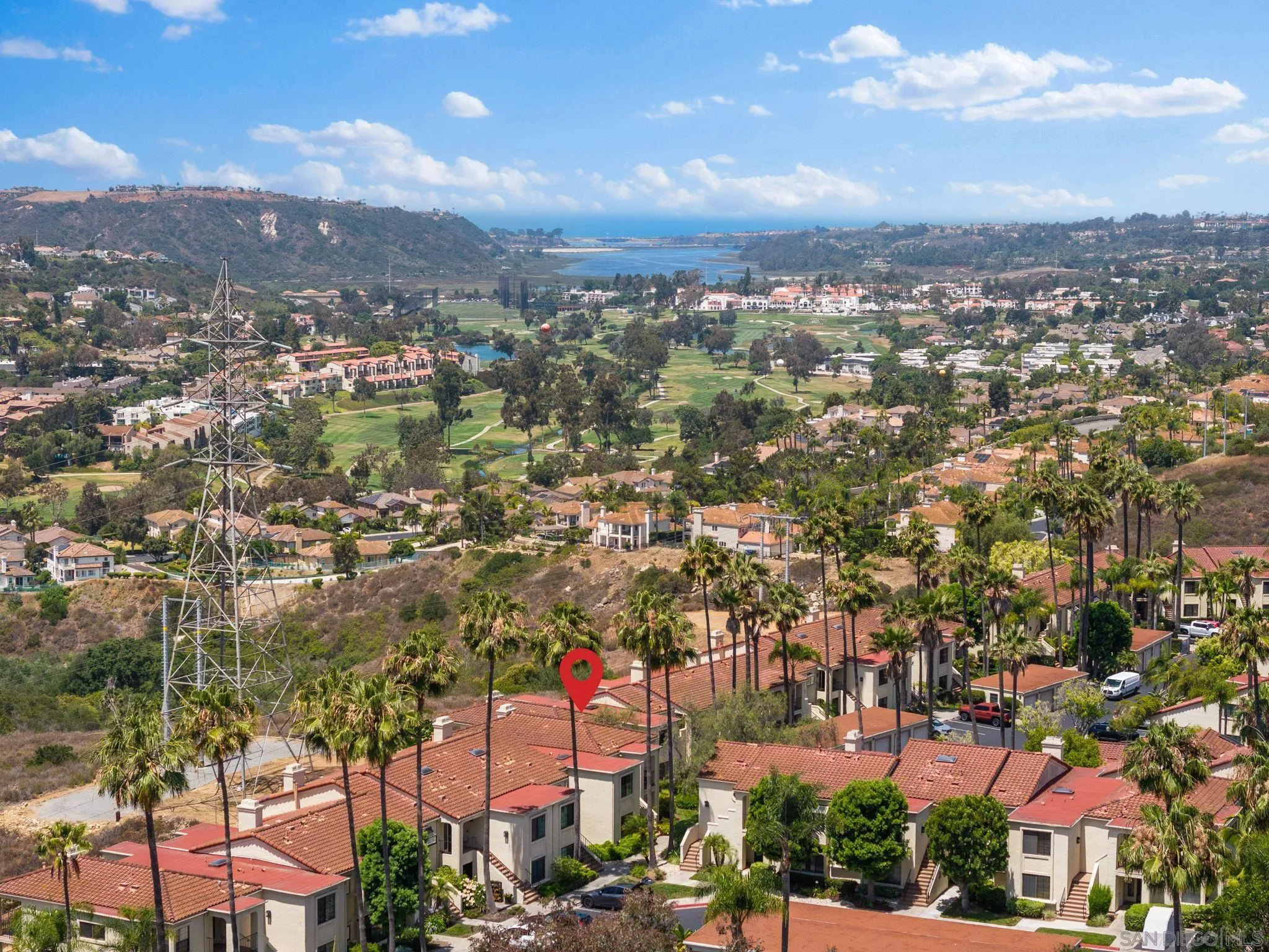 an aerial view of residential houses with city view
