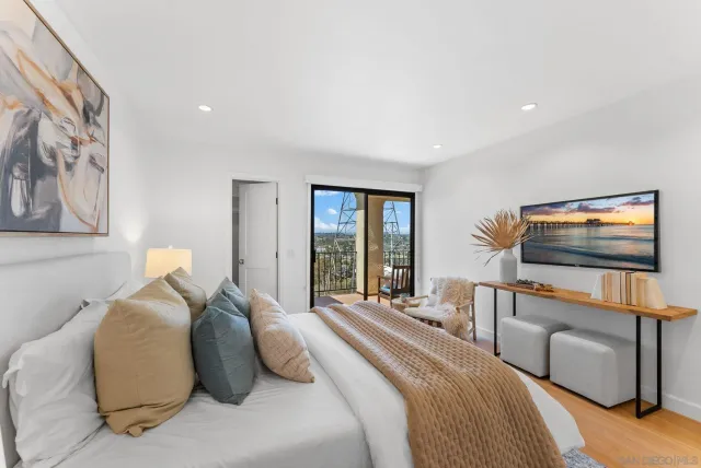 a bedroom with a bed and a flat screen tv