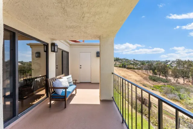 a view of balcony with furniture