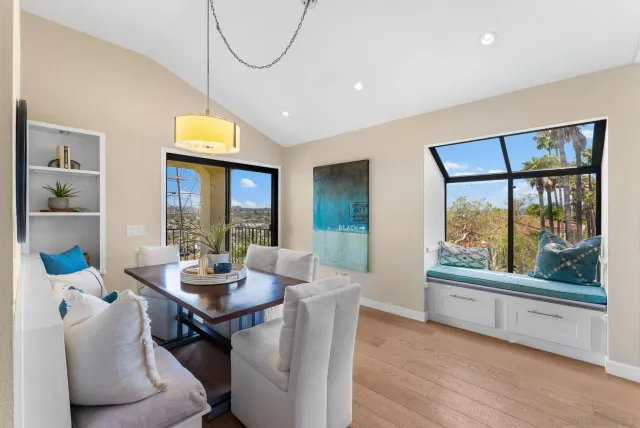 a dining room with furniture and wooden floor