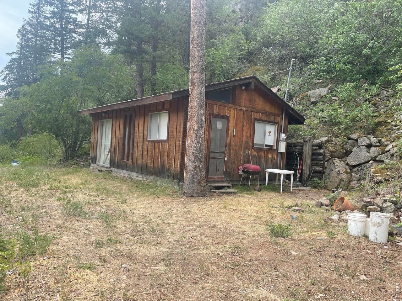 509 Riverside Drive Lyons, CO 80540 - Photo 1 of 15 a view of a house with a yard and wooden fence