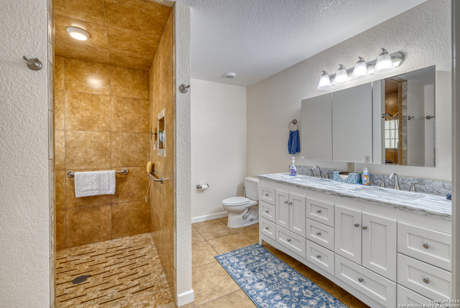1482 Flatrock Circle Rio Frio, TX 78879 - Photo 15 of 34 a bathroom with a granite countertop sink a toilet and shower